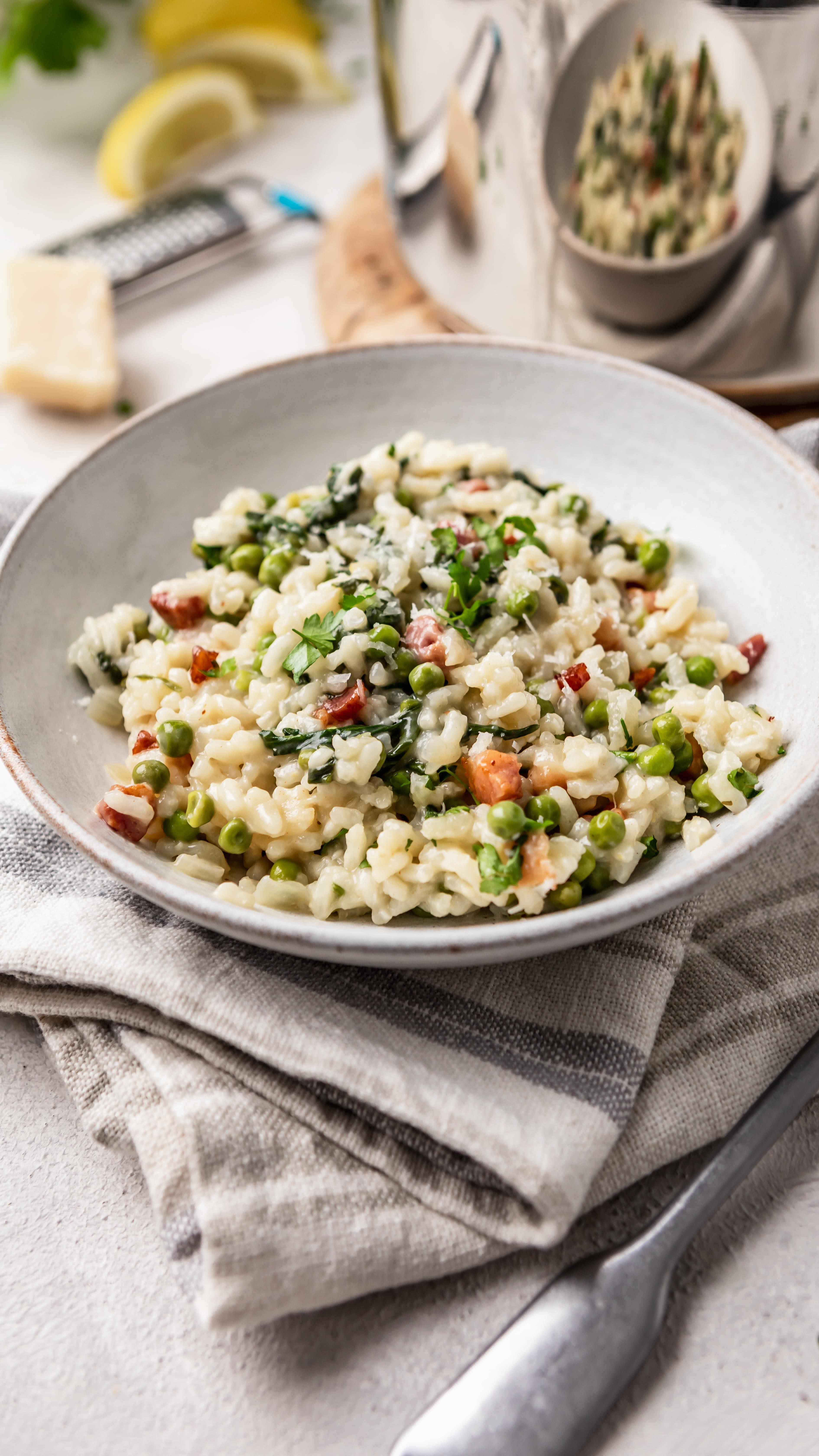 CREAMY PANCETTA AND SPRING VEGETABLE RISOTTO
 
 AD I’ve teamed up with @talacooking and created this delicious ‘Creamy Pancetta and Spring Vegetable Risotto’ using their NEW ‘20cm deep lidded saucepan’. It has an added handle making it easy to carry on and off the stove as well as Litre measurings on the side for ease when cooking.
 
What I love about this seasonal risotto recipe is it’s creaminess balanced with the crispy salty pancetta. It really is decadent but uses simple ingredients!
 
Don’t forget to hit SAVE to give this a try! And follow @talacooking for more recipes and cooking ideas!
 
SERVES 4-5
 
INGREDIENTS
 
1 tbsp olive oil
200g smoked pancetta
1 large onion, diced
3 garlic cloves, minced
350g risotto rice
1.5 litres hot chicken stock, made with 2 stock cubes
1/2 lemon, juiced
300g frozen peas
100g baby leaf spinach
100g Parmesan, grated
Black Pepper, to serve
 
METHOD
 
1. Add the olive oil to large saucepan. Fry the pancetta until crispy, then remove, leaving the oil in the pan and set aside.
2. Add the diced onion, and fry until softened (around 8 minutes) then add the minced garlic and fry for a further 2 minutes.
3. Add the rice and allow the oil to coat it. Stir for 1 minute before adding in the hot stock ladle by ladle, allowing the rice to absorb the stock after each addition. This will take around 25-30 minutes.
4. Keep adding the stock and stirring gently until the risotto is creamy in appearance and the rice is al dente. You may not need to add all the stock.
5. When adding the last ladle of stock, add the frozen peas and cook for a final 5 minutes until the rice and peas are cooked.
6. Grate in two-thirds of the Parmesan, add the spinach and crispy pancetta, stir through until spinach has wilted.
7. Serve in pasta bowls and garnish some cracked black pepper and the rest of the Parmesan.
.
.
#recipereels #dinnerrecipes #risotto #risottorecipe #foodreels #easydinner #trendingreels #foodie
