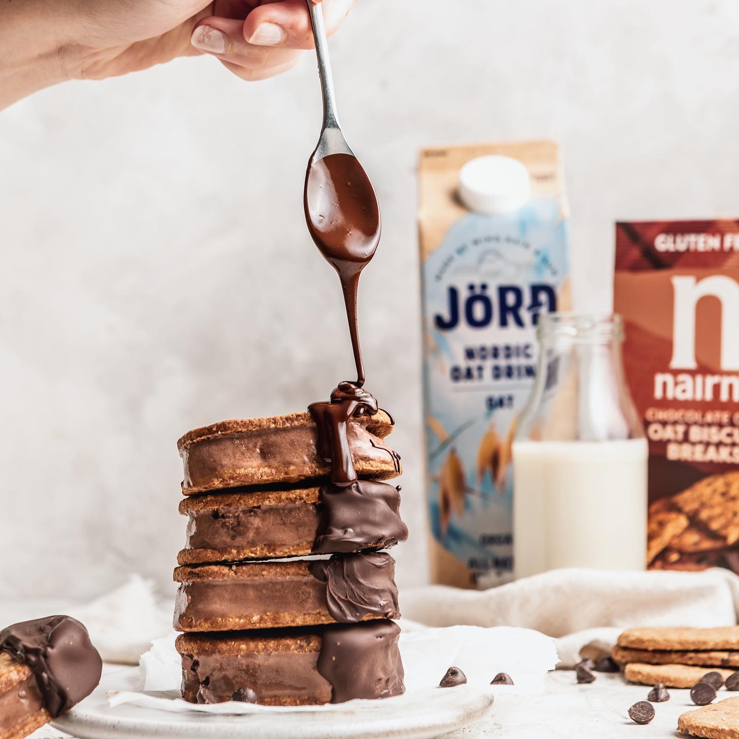 Vegan Chocolate Icecream Sandwiches//
I've teamed up with @morrisons to create this delicious and super easy recipe for you to try this weekend! Using @jordunitedkingdom organic oat drink to create a creamy chocolate ice cream, then sandwiched between two @nairnsoatcakes chocolate chip biscuit breaks and finally, dipped in chocolate 😍. Hit SAVE to give this recipe a try and head to your local Morrisons where you will find the oat milk and biscuit breaks on offer currently too! #AD

Ready in 20 minutes plus 4-6 hours freeze time

INGREDIENTS

1 x 400ml full fat coconut milk
80g light muscovado sugar
100ml Jord Nordic oat drink
30g coconut oil
2 tsp vanilla extract
1 tbsp cocoa powder
1 x 160g pack Nairn’s oat biscuit breaks, chocolate chip
(OPTIONAL) 100g Morrison’s free from chocolate bar, for dipping

METHOD

1. Add the coconut milk, sugar and milk to saucepan and place on a low heat, stirring until sugar has dissolved. Increase the heat to bring the mixture to a gentle simmer. Simmer for 5 minutes, whisking occasionally.
2. Remove from the heat, whisk through the coconut oil, vanilla extract and cocoa powder until fully combined.
3. Pour into suitable container and chill for 2 hours.
4. If using an ice cream maker, pour the chilled mix in and churn for 20-30 minutes until it turns into a soft scoop ice cream, then make the ice cream sandwiches.
5. If you don’t have an ice-cream maker, once the mixture is chilled, place in the freezer for 3-4 hours. Leave to stand for 10-15 minutes to soften slightly before scooping.
6. Take 2 oat biscuit breaks, scoop some ice cream on top of one biscuit and place another biscuit on top, repeat with all the biscuits.
7. If using, break the chocolate into pieces and place in a large microwave safe bowl, heat in 10-15 second increments stirring each time, until fully melted. Dip one end of the ice cream sandwich into the chocolate bowl and place onto a serving plate.
8. Serve straightaway or pop back in the freezer until ready to eat.

#morrisons #freefromevent #vegan #icecream #icecreamsandwiches #veganicecream #chocolate